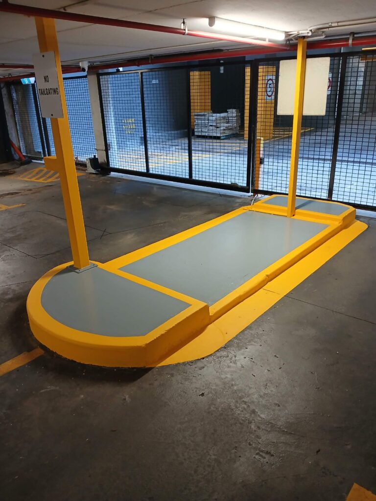Car park entry island recoated with floor coating and yellow line marking