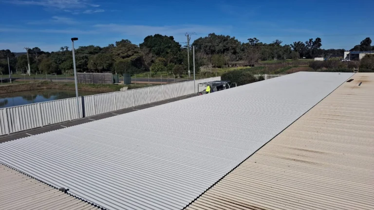 Car park shade structure re-roofing at Swan Valley Central, new roof sheeting installed beside original sheets