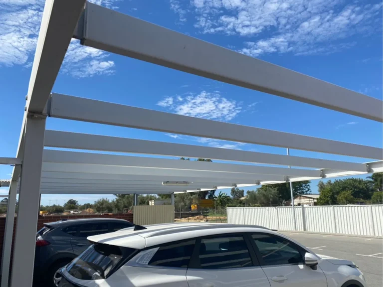 Existing steel rafters of car park shade structure prepared for new top hats and purlins
