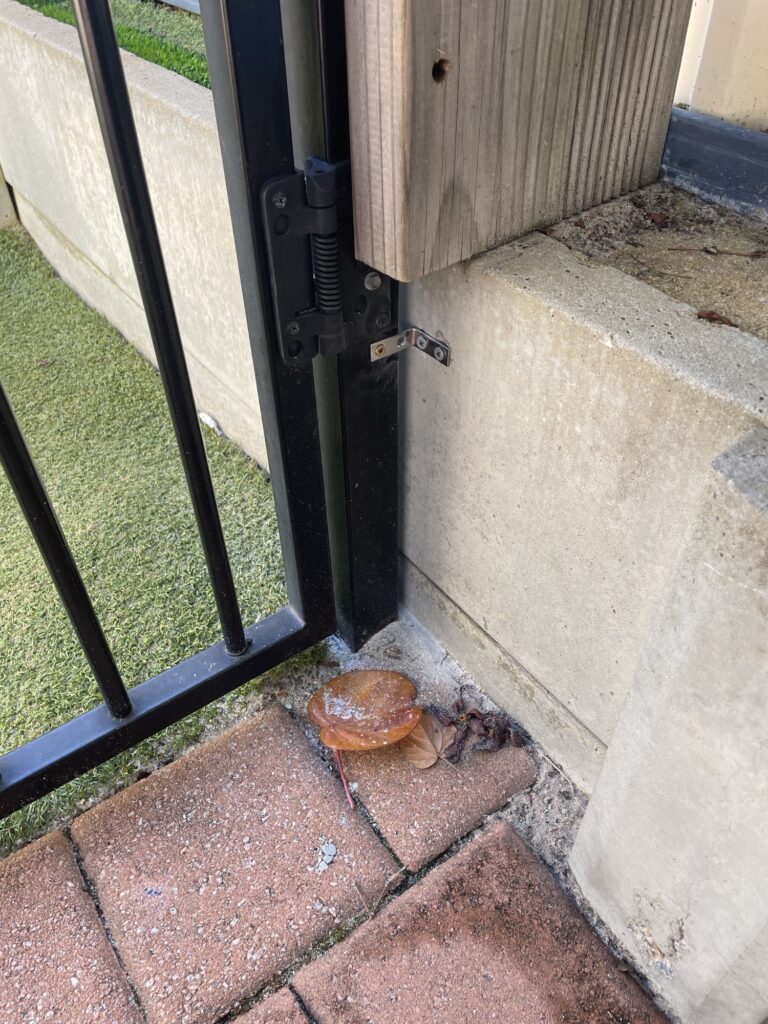 New wall bracket installed to support and realign the gate post