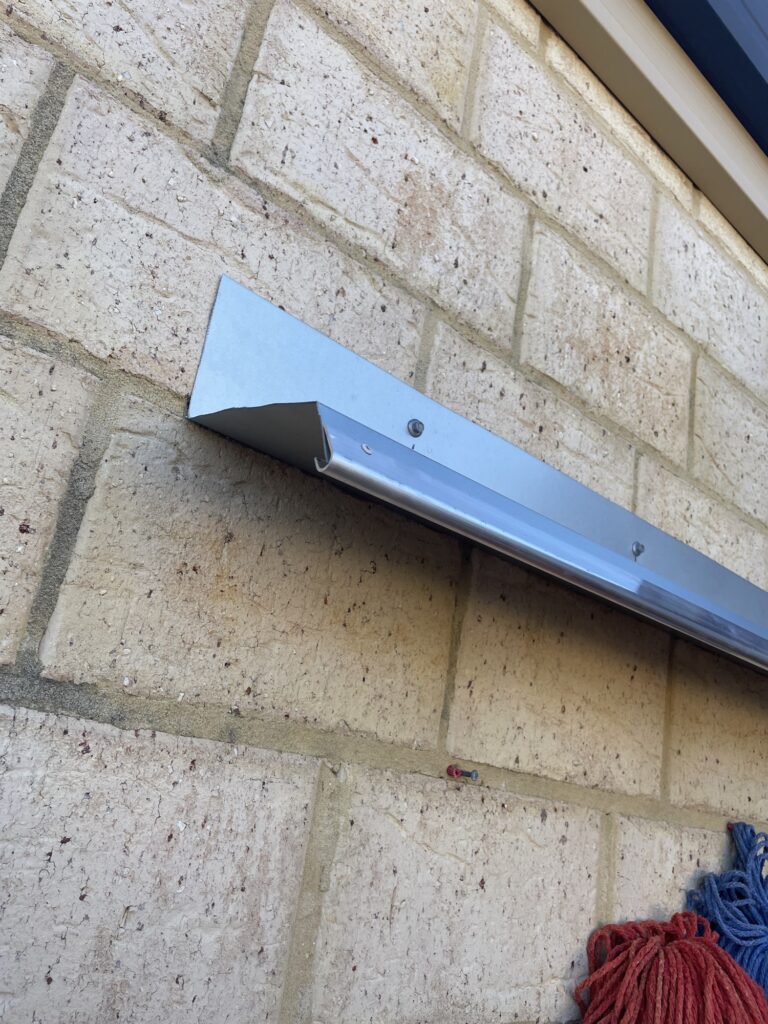 Custom flashing canopy shelf fixed to a block wall with nosing on the front edge