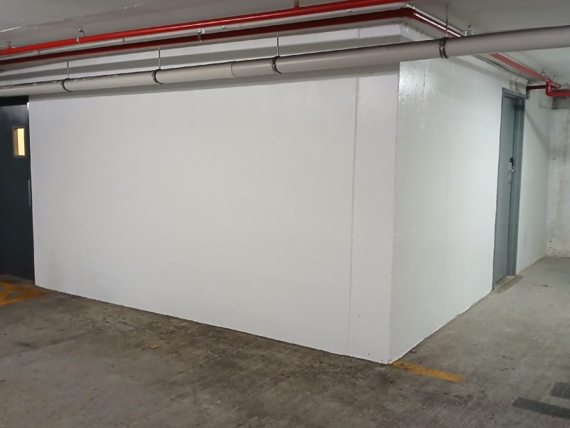 Freshly repainted car park walls after patching and preparation