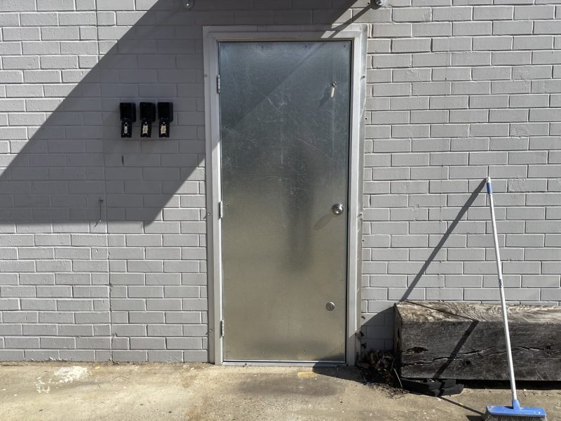 New commercial steel door with a canopy installed above the doorway