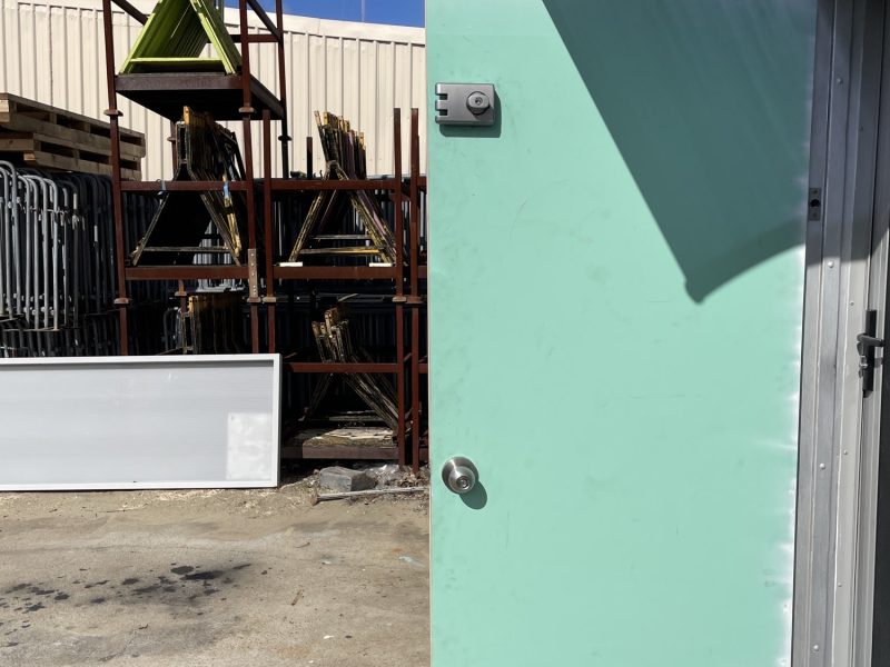 Replacement door being prepared and primed on site