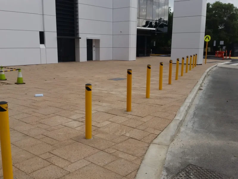 ctbm-yellow-bollards-commercial-building-entrance.webp