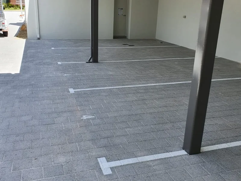 Undercover car park bays freshly line marked beside a column