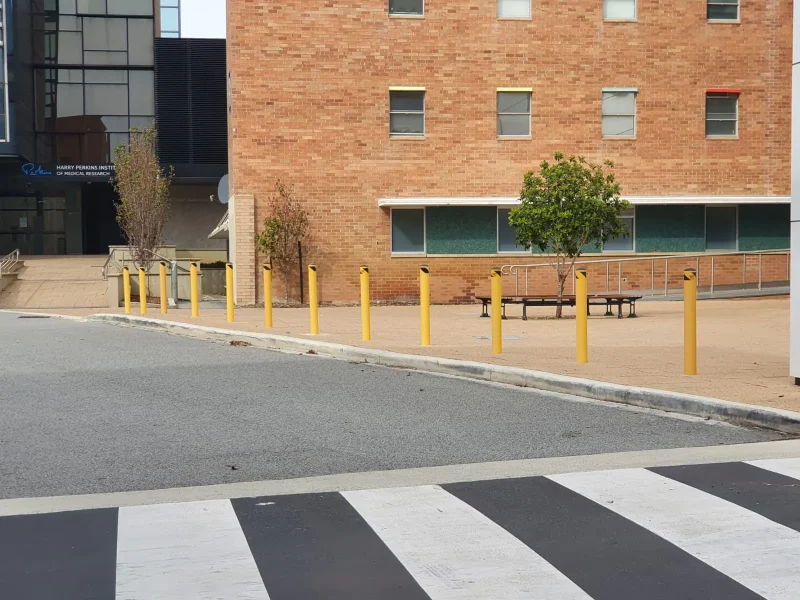 yellow-bollards-campus-entrance-installed.webp